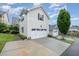 Two-story garage with a white door, complementing the neutral siding and well-maintained landscaping at 43 Salt Cedar Ln, Chapel Hill, NC 27516