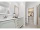 Bright primary bathroom featuring double sinks, vanity with storage, framed mirrors, and access to walk-in closet at 43 Salt Cedar Ln, Chapel Hill, NC 27516