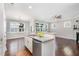 Open concept kitchen with granite countertops, stainless steel appliances, and view of the living and dining areas at 43 Salt Cedar Ln, Chapel Hill, NC 27516