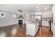Spacious open concept living area featuring hardwood floors, kitchen with stainless steel appliances, and a cozy fireplace at 43 Salt Cedar Ln, Chapel Hill, NC 27516
