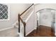 Carpeted staircase with a wood railing and white spindles, adjacent to a hallway with gleaming hardwood floors at 43 Salt Cedar Ln, Chapel Hill, NC 27516