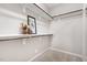 Bright walk-in closet featuring white shelves and decorative touches at 43 Salt Cedar Ln, Chapel Hill, NC 27516