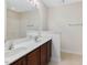 Bright bathroom features a double sink vanity with a large mirror and a shower-tub combo at 4719 Altha St, Raleigh, NC 27606