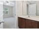Bathroom vanity with neutral walls, view into carpeted bedroom with great light at 4719 Altha St, Raleigh, NC 27606