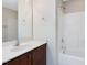 Well-lit bathroom with single sink vanity, spacious countertop, and a shower-tub combo at 4719 Altha St, Raleigh, NC 27606