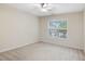 Bright bedroom featuring neutral colors, a ceiling fan, and a window at 4719 Altha St, Raleigh, NC 27606