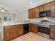 Bright kitchen featuring stainless steel appliances, wood cabinets, and hardwood flooring at 4719 Altha St, Raleigh, NC 27606
