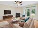 Inviting living room with a fireplace, complemented by hardwood floors and doors leading to the outside at 4719 Altha St, Raleigh, NC 27606