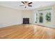 Bright living room featuring fireplace, hardwood floors, and a ceiling fan at 4719 Altha St, Raleigh, NC 27606