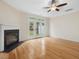 Spacious living room with hardwood flooring, fireplace and french doors to the back yard at 4719 Altha St, Raleigh, NC 27606