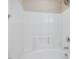 Clean white tiled shower-tub combo features a sleek shower head and updated fixtures at 4719 Altha St, Raleigh, NC 27606