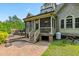 Backyard featuring a screened porch, deck, brick patio, and a bicycle at 4720 Yates Mill Pond Rd, Raleigh, NC 27606