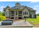 Spacious backyard featuring a brick patio, deck, propane tank, and a grill at 4720 Yates Mill Pond Rd, Raleigh, NC 27606