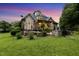 A beautiful backyard boasts a hot tub, and an outdoor cooking area with a stone countertop at 4720 Yates Mill Pond Rd, Raleigh, NC 27606