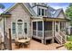 Backyard featuring a deck, screened porch, stairs, and a table with chairs at 4720 Yates Mill Pond Rd, Raleigh, NC 27606