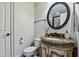 Charming bathroom with an ornate vanity, decorative mirror, and a toilet at 4720 Yates Mill Pond Rd, Raleigh, NC 27606