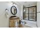 Well-maintained bathroom showcasing a sink, toilet, mirror, and a shower with a glass door at 4720 Yates Mill Pond Rd, Raleigh, NC 27606