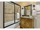 A bathroom showcases a shower over tub and a vanity with framed mirror at 4720 Yates Mill Pond Rd, Raleigh, NC 27606