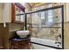 Rustic bathroom featuring a wood vanity, unique mirror, and a tiled shower at 4720 Yates Mill Pond Rd, Raleigh, NC 27606
