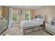 Cozy bedroom featuring a comfortable bed, bedside table, and windows with natural light at 4720 Yates Mill Pond Rd, Raleigh, NC 27606
