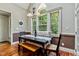 This dining nook features wainscoting, wood floors, and a large window at 4720 Yates Mill Pond Rd, Raleigh, NC 27606