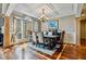 Charming dining area featuring large windows, hardwood floors, and stylish chandelier at 4720 Yates Mill Pond Rd, Raleigh, NC 27606