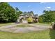 A charming two-story home with a circular driveway and well-manicured landscaping at 4720 Yates Mill Pond Rd, Raleigh, NC 27606