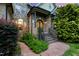 Beautiful stone and brick home with meticulously landscaped front yard and inviting arched entryway at 4720 Yates Mill Pond Rd, Raleigh, NC 27606