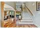 Bright foyer showcasing hardwood floors, staircase, and open layout to the living and dining areas at 4720 Yates Mill Pond Rd, Raleigh, NC 27606
