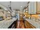 An open kitchen design features a large center island, stainless appliances, and wood cabinets at 4720 Yates Mill Pond Rd, Raleigh, NC 27606