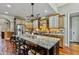 A kitchen features a large center island, granite countertops and wood floors at 4720 Yates Mill Pond Rd, Raleigh, NC 27606