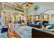 Open-concept living room flows into the kitchen and dining area with hardwood floors and large windows at 4720 Yates Mill Pond Rd, Raleigh, NC 27606