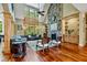 Bright living room with vaulted ceilings, stone fireplace, and expansive windows overlooking the yard at 4720 Yates Mill Pond Rd, Raleigh, NC 27606