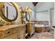 The ensuite bathroom features a jacuzzi tub and double sinks, perfect for a relaxing evening at 4720 Yates Mill Pond Rd, Raleigh, NC 27606