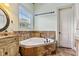 Bright bathroom featuring a jacuzzi soaking tub, and single sink at 4720 Yates Mill Pond Rd, Raleigh, NC 27606