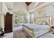 Bright main bedroom boasts french doors to a balcony and vaulted ceiling with a wood accent at 4720 Yates Mill Pond Rd, Raleigh, NC 27606