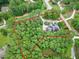 Aerial view outlining the property within a wooded area, showing its location relative to nearby roads and houses at 4924 Stoneyoak Ln, Raleigh, NC 27610