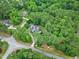 Aerial view of a property surrounded by dense woods, highlighting its privacy and serene setting at 4924 Stoneyoak Ln, Raleigh, NC 27610