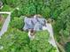 This high aerial view shows the house and the mature trees surrounding the property at 4924 Stoneyoak Ln, Raleigh, NC 27610
