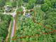 This aerial perspective outlines the home's property lines, showcasing its wooded lot and surrounding landscape at 4924 Stoneyoak Ln, Raleigh, NC 27610