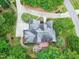 Breathtaking aerial view of home with mature landscaping, circular driveway, and gray roof at 4924 Stoneyoak Ln, Raleigh, NC 27610