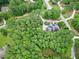 High-angle view of a home nestled among trees, revealing its spacious layout and landscaped yard at 4924 Stoneyoak Ln, Raleigh, NC 27610