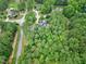 Aerial view shows the home's placement within a lush, wooded neighborhood, emphasizing its peaceful setting at 4924 Stoneyoak Ln, Raleigh, NC 27610
