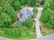 Stunning aerial view of the home surrounded by lush greenery and a well-manicured lawn at 4924 Stoneyoak Ln, Raleigh, NC 27610