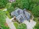 An aerial view displays this stately home and the wooded lot on which it sits at 4924 Stoneyoak Ln, Raleigh, NC 27610