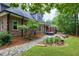 A view of the backyard showcases the landscaping, stone path, and the back deck at 4924 Stoneyoak Ln, Raleigh, NC 27610