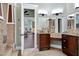 Well-lit bathroom featuring dual vanities, granite counters, and an open doorway at 4924 Stoneyoak Ln, Raleigh, NC 27610