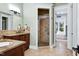 Bathroom featuring a double vanity with granite countertops and a glass shower at 4924 Stoneyoak Ln, Raleigh, NC 27610