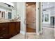 Bathroom showcasing tile shower with bench and dual vanity with granite counters at 4924 Stoneyoak Ln, Raleigh, NC 27610