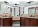 Bathroom featuring dual vanities, granite counters, with custom mirrors at 4924 Stoneyoak Ln, Raleigh, NC 27610